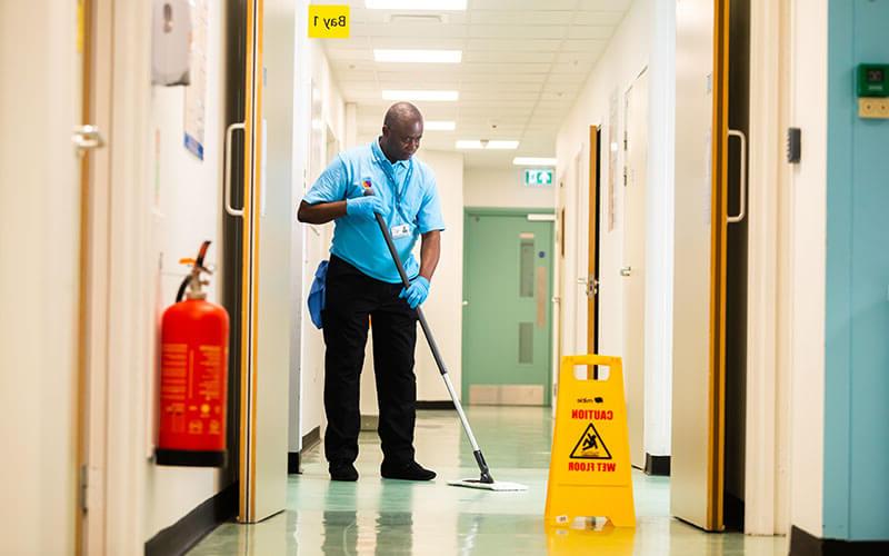 Hospital cleaner mopping floor